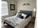 This cozy bedroom features a comfortable bed, complemented by stylish decor and natural light from the window at 4164 River Shoals Ct, Duluth, GA 30097
