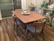 Bright dining area with wooden table, four chairs, and stylish decor, creating a warm, inviting atmosphere at 4164 River Shoals Ct, Duluth, GA 30097