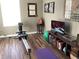 Exercise room featuring a rowing machine, mounted television, and a green yoga ball at 4164 River Shoals Ct, Duluth, GA 30097
