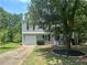 Charming two-story home with a well-manicured lawn and mature tree offering shade and curb appeal at 4164 River Shoals Ct, Duluth, GA 30097