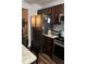 Modern kitchen featuring stainless steel appliances, granite counters, and dark cabinets at 4164 River Shoals Ct, Duluth, GA 30097