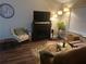 Cozy living room with a fireplace, stylish decor, hardwood floors and comfortable seating at 4164 River Shoals Ct, Duluth, GA 30097