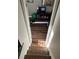 Staircase leading to exercise room with rowing machine and television, all with wood laminate floors at 4164 River Shoals Ct, Duluth, GA 30097