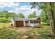 Wide shot of the backyard, complete with brick exterior and screened in porch at 6000 Malibu Drive Dr, Morrow, GA 30260
