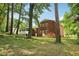 A lush backyard featuring a brick home with white trim, and screened in porch at 6000 Malibu Drive Dr, Morrow, GA 30260