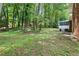 Lush backyard of the home with screened in porch and lots of trees at 6000 Malibu Drive Dr, Morrow, GA 30260