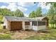 Wide shot of the backyard with trees, brick exterior and screened in porch at 6000 Malibu Drive Dr, Morrow, GA 30260