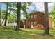 Brick home with a screened in porch viewed from the lush backyard at 6000 Malibu Drive Dr, Morrow, GA 30260