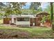 View of the backyard with brick home, white trim, and a screened in porch at 6000 Malibu Drive Dr, Morrow, GA 30260
