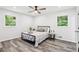 Light and airy bedroom with ceiling fan, two windows and modern flooring at 6000 Malibu Drive Dr, Morrow, GA 30260