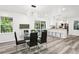 Open dining and kitchen area with hardwood floors and a modern light fixture at 6000 Malibu Drive Dr, Morrow, GA 30260