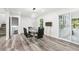 Contemporary dining area with hardwood floors, modern light fixture, and backyard access at 6000 Malibu Drive Dr, Morrow, GA 30260