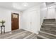 Welcoming foyer with wood-look floors, staircase, coat closet, and decorative glass front door at 6000 Malibu Drive Dr, Morrow, GA 30260