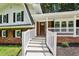 View of the front porch with brick siding, pendant lights, and a secure, modern door lock at 6000 Malibu Drive Dr, Morrow, GA 30260