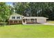 Charming two-story home with brick accents, white siding, and a welcoming covered front porch at 6000 Malibu Drive Dr, Morrow, GA 30260