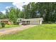 This home features a charming two-story design, an attached two-car garage, and a large lawn at 6000 Malibu Drive Dr, Morrow, GA 30260