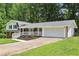 This home features a charming two-story design, an attached two-car garage, and mature trees at 6000 Malibu Drive Dr, Morrow, GA 30260