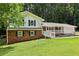 Charming two-story home with brick accents, white siding, and a welcoming covered front porch at 6000 Malibu Drive Dr, Morrow, GA 30260