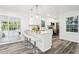 Open kitchen featuring white cabinetry, stainless steel appliances, and barstool seating at 6000 Malibu Drive Dr, Morrow, GA 30260