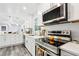 Updated kitchen with stainless steel appliances, white cabinetry, and lots of light at 6000 Malibu Drive Dr, Morrow, GA 30260