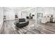 Open floor plan with hardwood floors connecting living, dining, and kitchen spaces at 6000 Malibu Drive Dr, Morrow, GA 30260