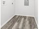 A clean room with gray wood flooring and white walls, offering a versatile space at 6000 Malibu Drive Dr, Morrow, GA 30260