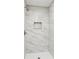 Contemporary shower features marble tile and built-in shelving at 6000 Malibu Drive Dr, Morrow, GA 30260