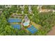 Aerial view of community amenities showcasing tennis courts, a pool, and a clubhouse surrounded by lush greenery at 87 Rushing View Gln, Dallas, GA 30157