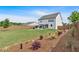 Expansive backyard with a pergola, fire pit area, and landscaping, offering privacy and outdoor enjoyment at 87 Rushing View Gln, Dallas, GA 30157