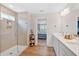 Modern bathroom featuring double sinks, shower with glass door, and stylish lighting at 87 Rushing View Gln, Dallas, GA 30157