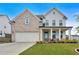 Charming two-story home with a brick and siding facade, well-manicured lawn, and an attached two-car garage at 87 Rushing View Gln, Dallas, GA 30157