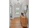 Inviting foyer with a stylish wooden console table and view of the entrance door, illuminated by a modern light fixture at 87 Rushing View Gln, Dallas, GA 30157