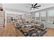 Open-concept living area with hardwood floors, a modern ceiling fan, and lots of natural light at 87 Rushing View Gln, Dallas, GA 30157