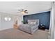 Inviting main bedroom with a striking accent wall, ceiling fan, and plush carpeting at 87 Rushing View Gln, Dallas, GA 30157