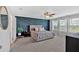 Spacious bedroom with custom blue accent wall, plush carpet, and ample natural light from large windows at 87 Rushing View Gln, Dallas, GA 30157