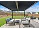 Relaxing backyard patio with an elegant pergola and comfortable seating; perfect for outdoor entertaining at 87 Rushing View Gln, Dallas, GA 30157
