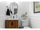Bathroom featuring a modern vanity, stylish mirror, and a toilet, all complemented by shiplap walls at 2316 Defoors Ferry Nw Rd, Atlanta, GA 30318
