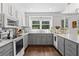 Spacious kitchen featuring gray cabinets, granite countertops, stainless steel appliances, and hardwood floors at 2316 Defoors Ferry Nw Rd, Atlanta, GA 30318
