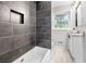 Modern bathroom featuring gray tile shower, white vanity, and decorative backsplash at 3068 Cherry Blossom Ln, Atlanta, GA 30344