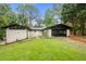 Charming ranch-style home with a well-manicured lawn, white brick, a black roof, and a two-car garage at 3068 Cherry Blossom Ln, Atlanta, GA 30344