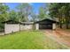 Charming ranch-style home with a well-manicured lawn, white brick, a black roof, and a two-car garage at 3068 Cherry Blossom Ln, Atlanta, GA 30344