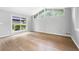 Bright living room featuring hardwood floors, large windows and white walls at 3068 Cherry Blossom Ln, Atlanta, GA 30344