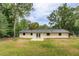Spacious backyard featuring a well-maintained lawn and rear view of a white painted brick home at 4176 King Edward Dr, Douglasville, GA 30135