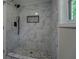Luxurious walk-in shower featuring elegant marble tiling, a rainfall shower head, and a stone pebble floor at 4176 King Edward Dr, Douglasville, GA 30135