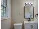 Modern bathroom features a sleek vanity with black hardware and framed mirror at 4176 King Edward Dr, Douglasville, GA 30135