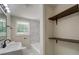 Bathroom with marble tiled shower, modern fixtures, and natural light from a window at 4176 King Edward Dr, Douglasville, GA 30135