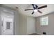 Bedroom features a ceiling fan, closet, and natural light from the window at 4176 King Edward Dr, Douglasville, GA 30135