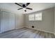 Bedroom features a double window, closet with bi-fold doors and wood-look floors at 4176 King Edward Dr, Douglasville, GA 30135