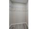 Walk-in closet with custom shelving and attractive wood-look floors, ready for organization and storage at 4176 King Edward Dr, Douglasville, GA 30135