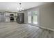 Bright kitchen features stainless steel appliances, white cabinets, and modern light fixtures at 4176 King Edward Dr, Douglasville, GA 30135